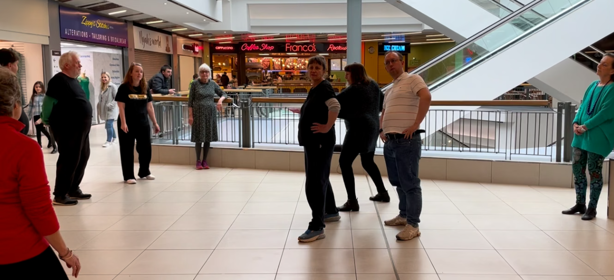 Moving Memory's Damn It! Dance It! group performing their choreography in a shopping centre to the great delight of shoppers and staff.
